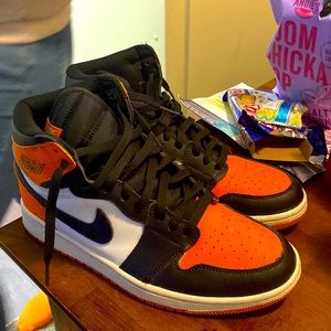 Orange black and white Jordan 1s